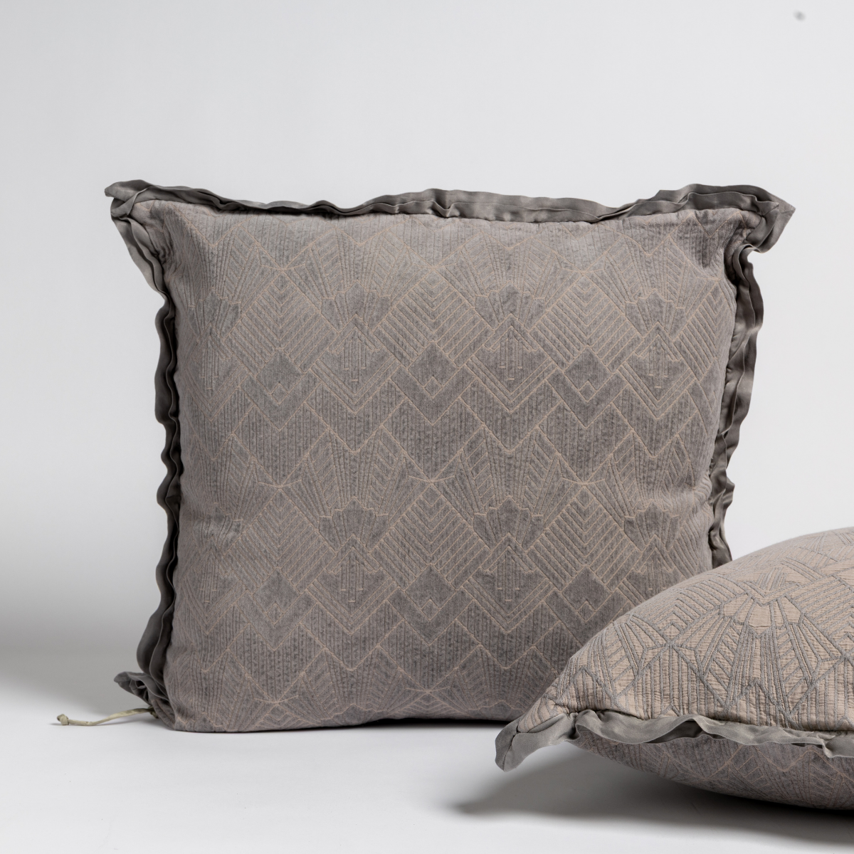 Bella Notte Trettino Sham in autumn-colored fabric, showcasing soft textile with elegant stitching details.