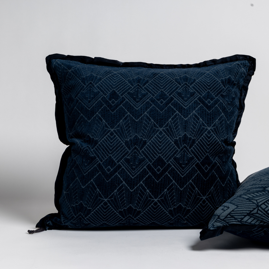 Bella Notte Trettino Sham in a cozy, textured fabric, displayed alongside matching throw pillows in warm autumn tones.