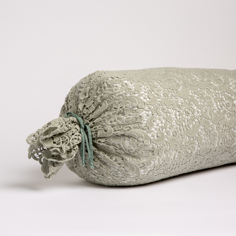 Bella Notte Allora Lace Bolster Cover on a throw pillow with delicate lace details and soft fabric in a cozy, elegant design.