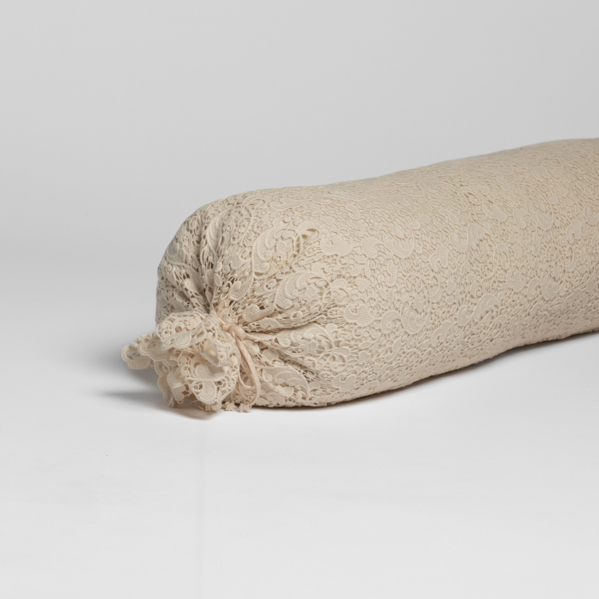 Natural lace bolster cover by Bella Notte, decorative throw pillow with intricate lace design in a natural color.
