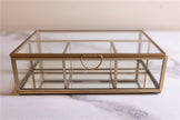 Four-section glass and brass box by BIDK, featuring a stylish multi-compartment design for elegant storage.