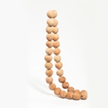 Terracotta clay tabletop beads with natural earthy tones, arranged in a decorative pattern for craft or home decor.