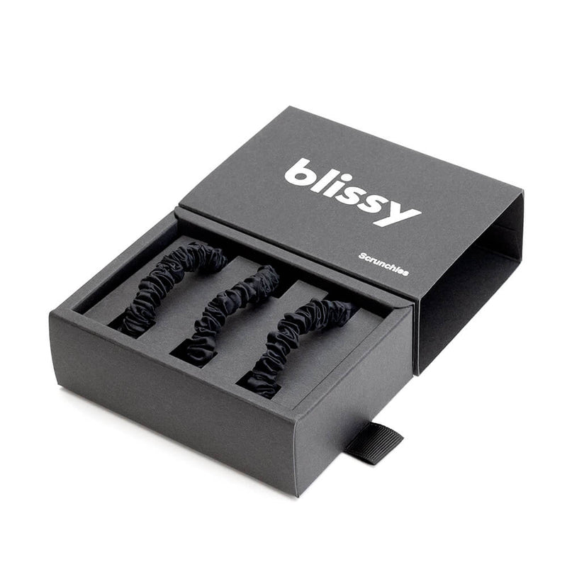 Set of three white Blissy Scrunchies, skinny style, made for gentle hair care and wellness, displayed in a close-up shot.