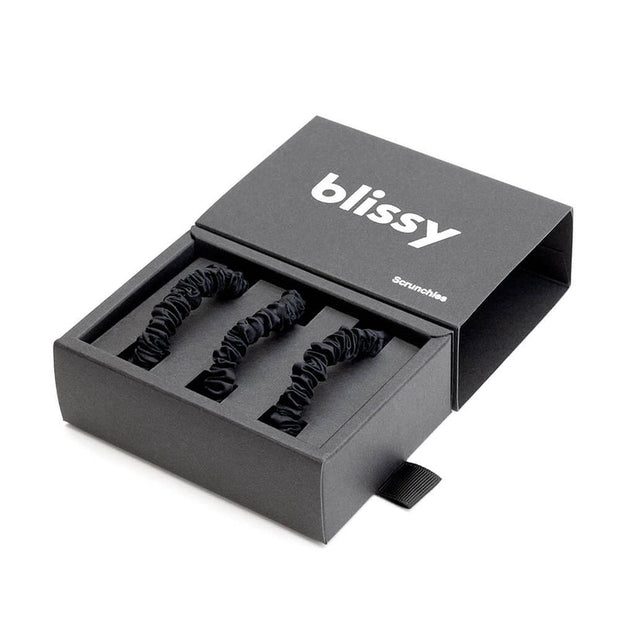 Set of three white Blissy Scrunchies, skinny style, made for gentle hair care and wellness, displayed in a close-up shot.