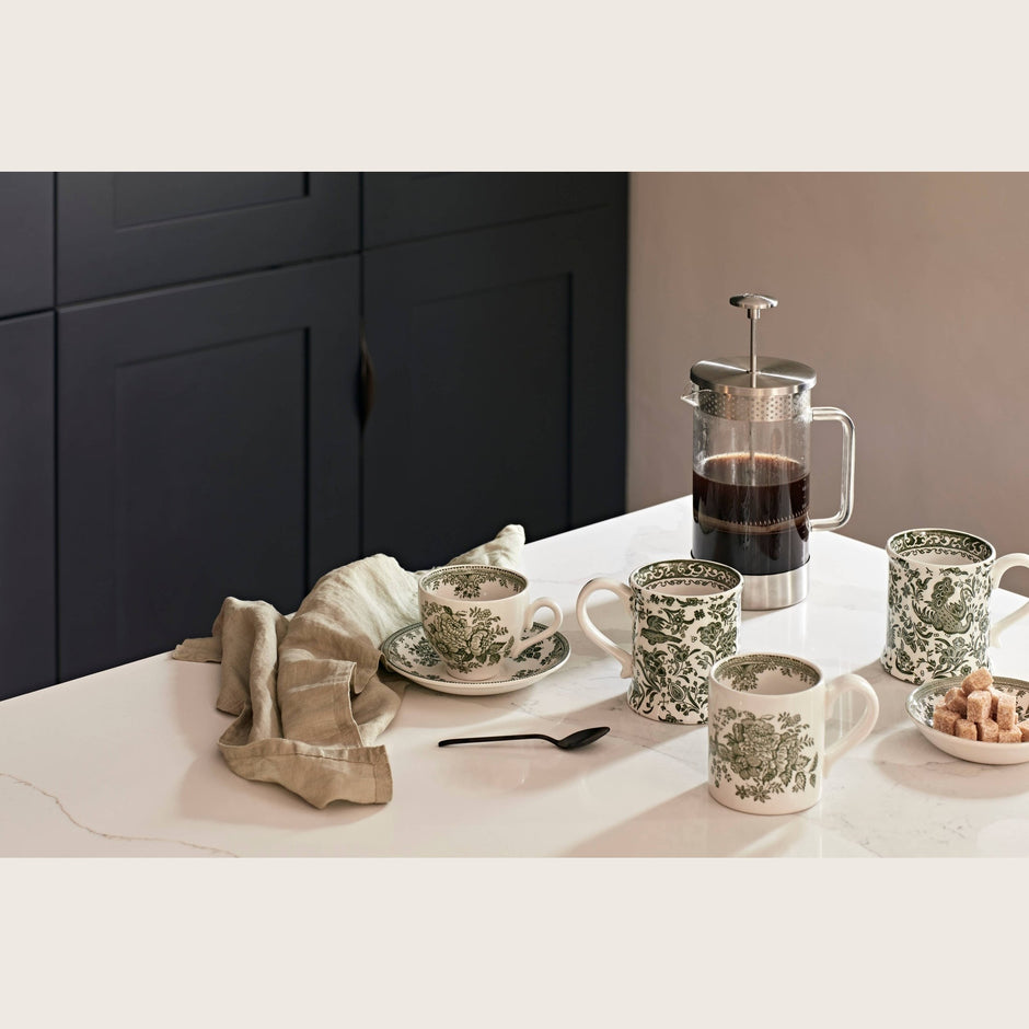 Dark green Asiatic Pheasants saucer by Burleigh, featuring intricate bird and floral patterns on ceramic tableware.