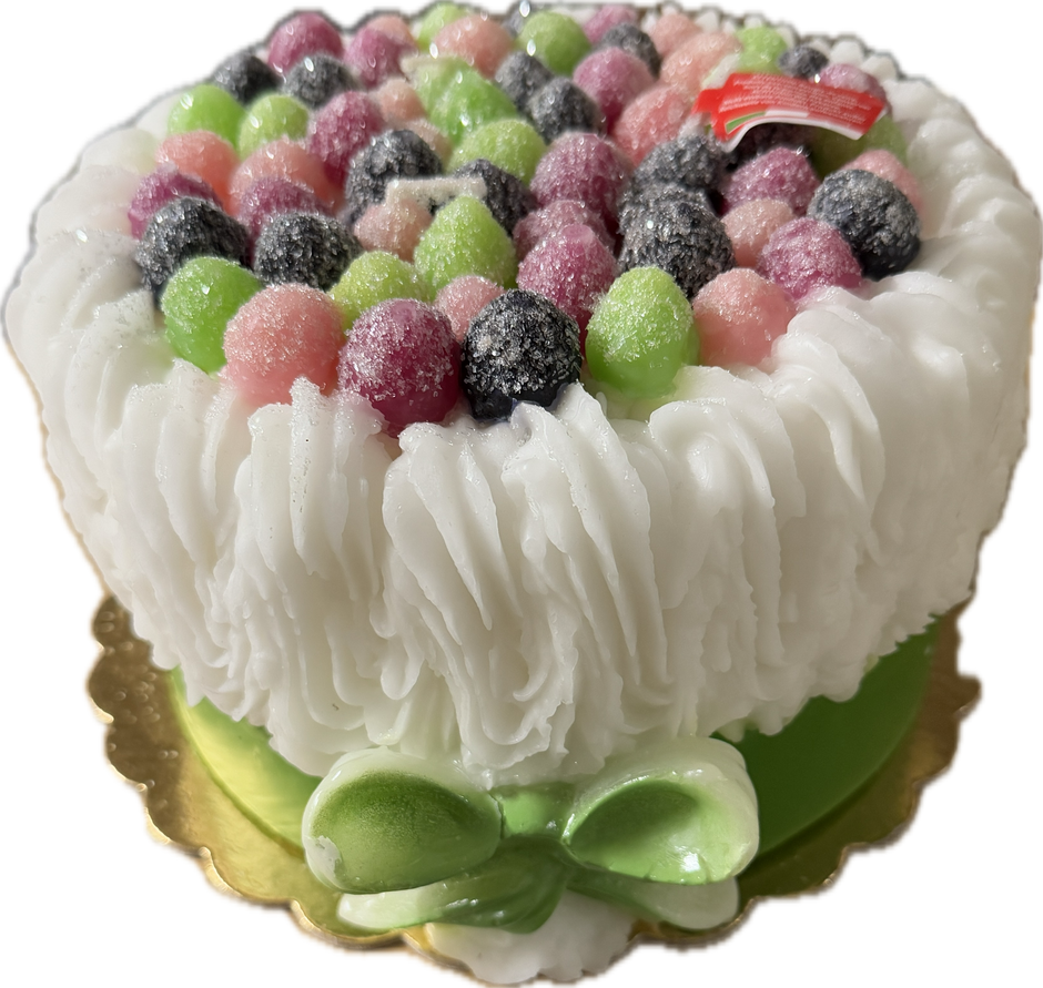 Cereria Introna Blackberry Cake pillar candle with green icing and candle wick, showcasing a decorative and fragrant candle design.