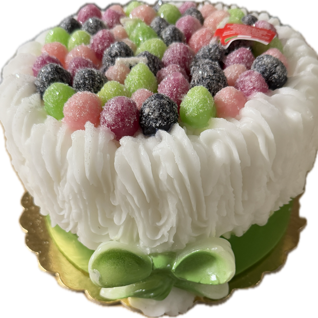 Cereria Introna Blackberry Cake pillar candle with green icing and candle wick, showcasing a decorative and fragrant candle design.