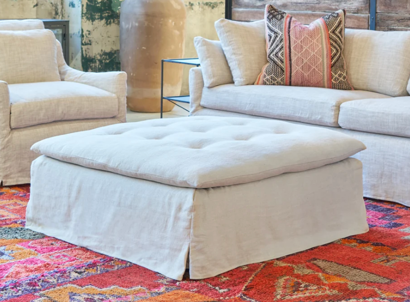 Cisco Sage Square Ottoman Slipcovered in Brevard Birch fabric, showcasing a modern, slipcovered design with a comfortable, square shape.