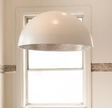 White Cisco Bolle pendant light hanging from ceiling, modern pendant lamp with sleek design and smooth finish.