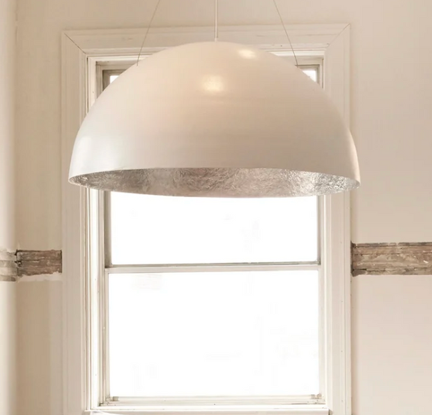 White Cisco Bolle pendant light hanging from ceiling, modern pendant lamp with sleek design and smooth finish.