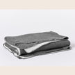 Coyuchi organic cotton blanket in charcoal for king size bed, soft and cozy bedding made from natural cotton.