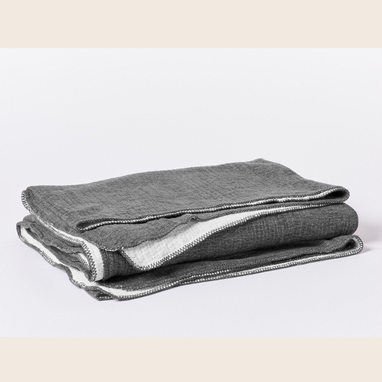 Coyuchi organic cotton blanket in charcoal for king size bed, soft and cozy bedding made from natural cotton.
