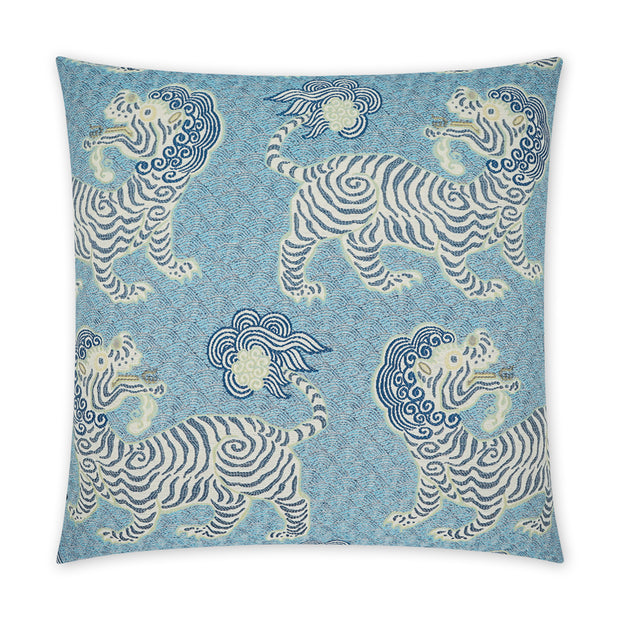 Decorative pillow with blue and white tiger pattern on a blue background