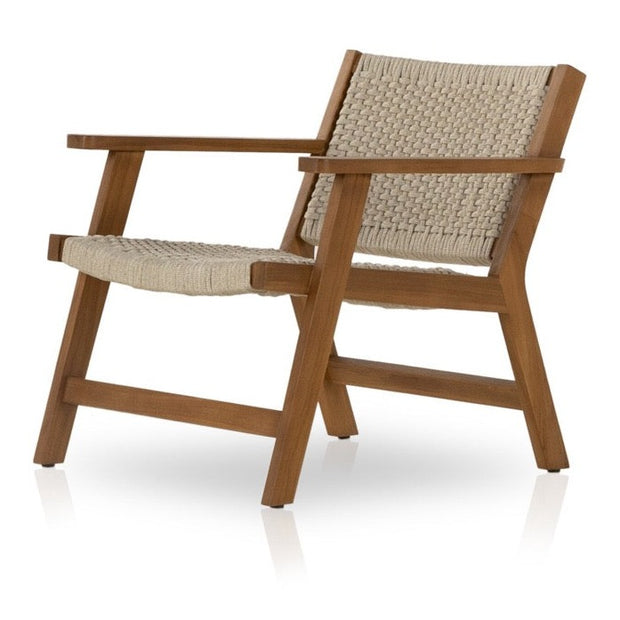 Four Hands Delano outdoor armchair with a modern design, featuring a cushioned seat and sturdy frame for outdoor seating.
