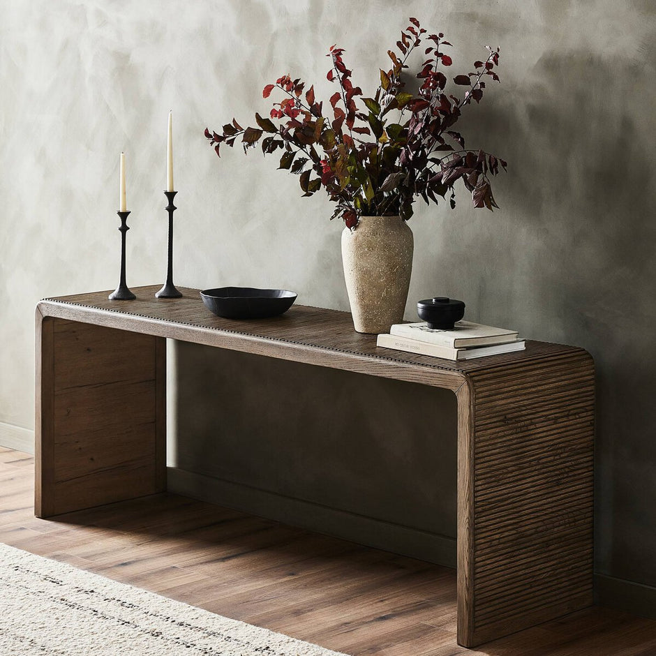 Four Hands Leo console table with a sleek wooden surface and metal legs, ideal for stylish entryways or living rooms.