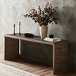 Four Hands Leo console table with a sleek wooden surface and metal legs, ideal for stylish entryways or living rooms.