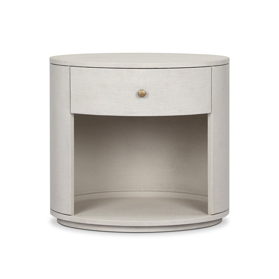 Amelia Oval One-Drawer Nightstand by Four Hands with ivory linen finish and sleek oval design.