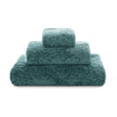 Graccioza Egoist hand towel in white with plush, textured fabric, displayed folded on a clean bathroom countertop.