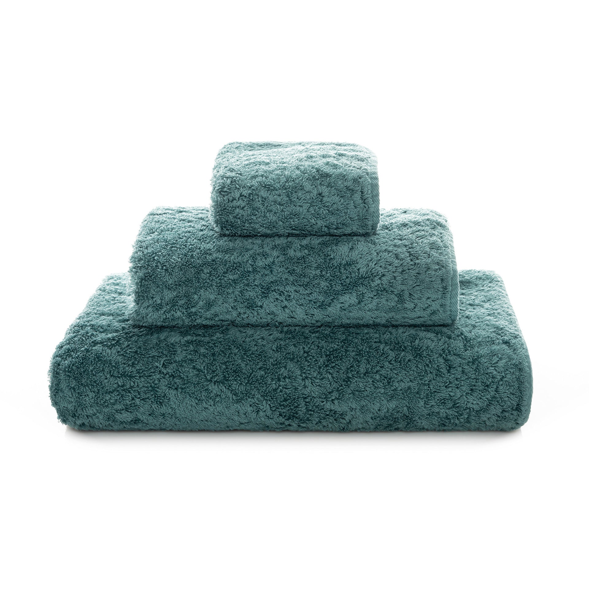 Graccioza Egoist hand towel in white with plush, textured fabric, displayed folded on a clean bathroom countertop.