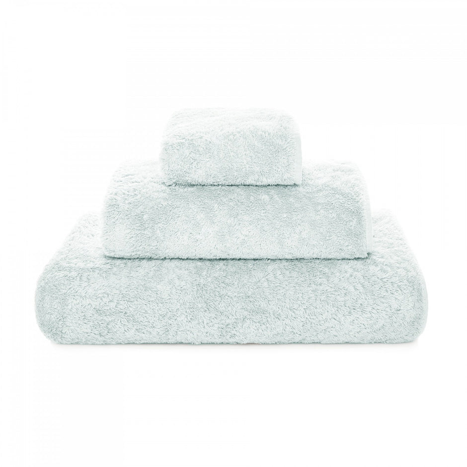 Graccioza Egoist hand towel in soft, plush fabric with a subtle pattern, displayed folded on a clean bathroom surface.