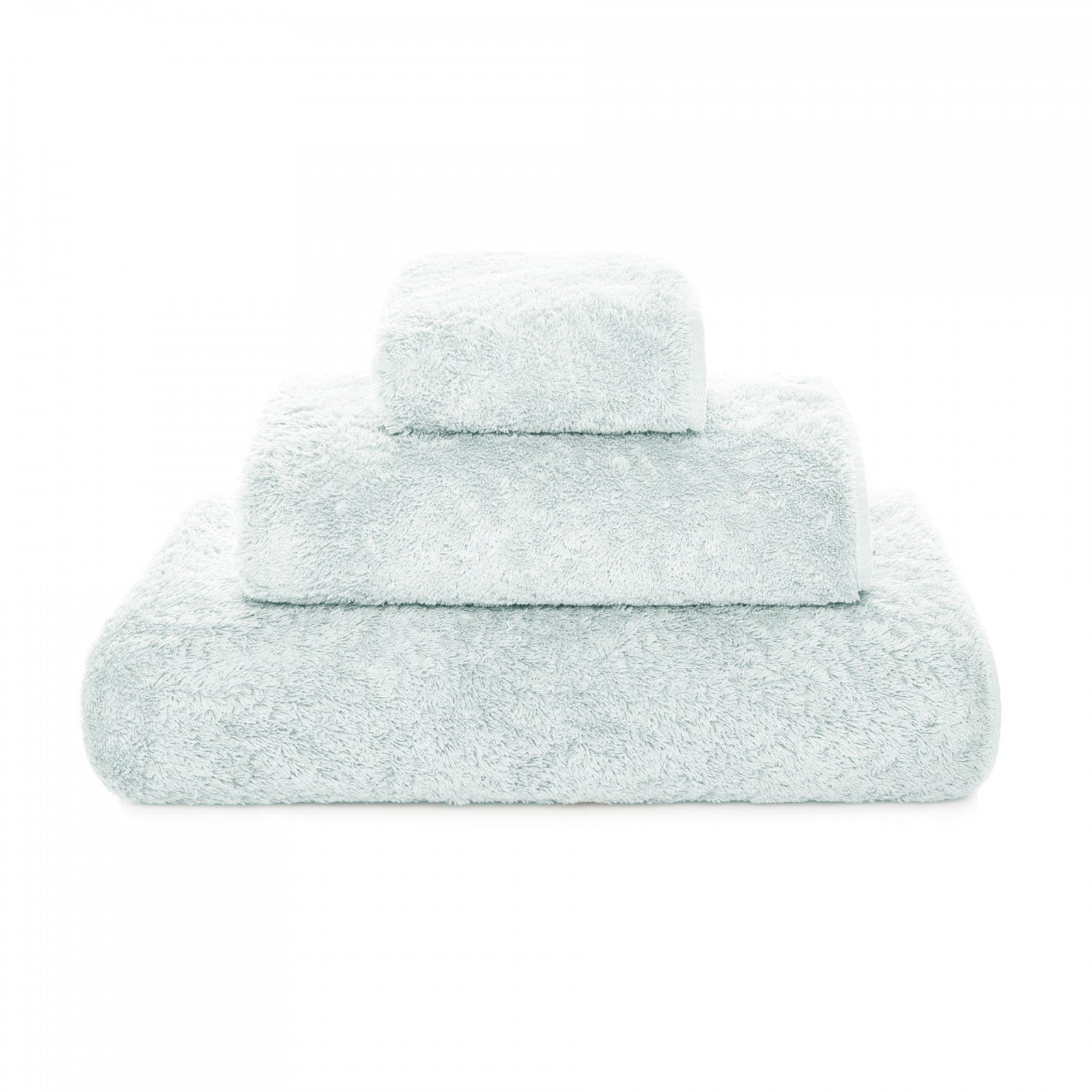 Graccioza Egoist hand towel in soft, plush fabric with a subtle pattern, displayed folded on a clean bathroom surface.