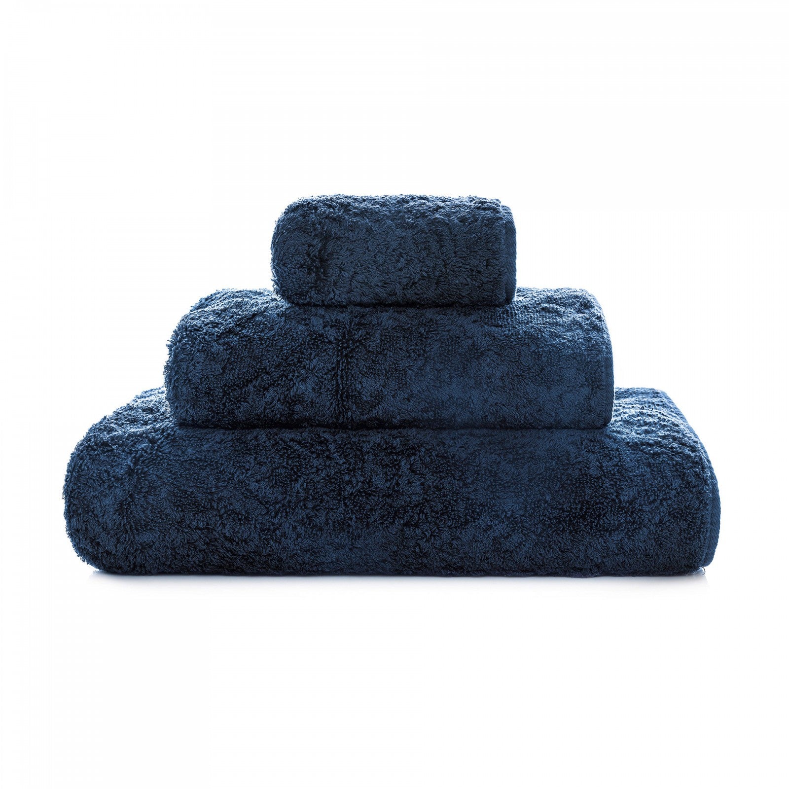 Graccioza Egoist hand towel in soft, white cotton with textured weave, displayed folded on a bathroom countertop.