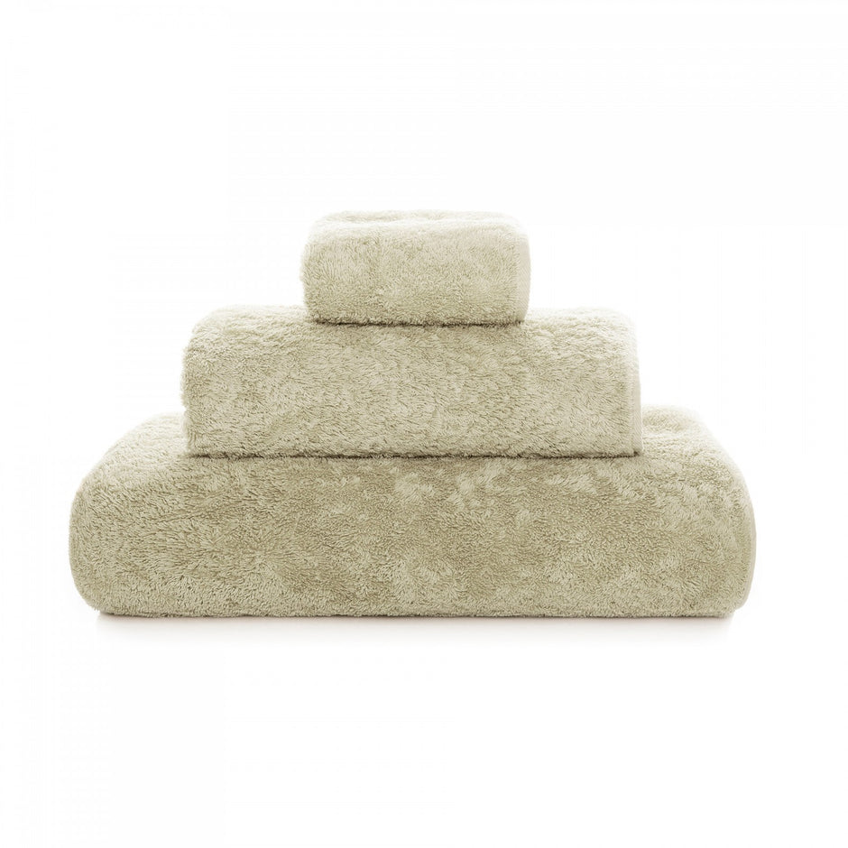 Graccioza Egoist hand towel with plush white fabric and subtle striped pattern, displayed folded on a neutral background.