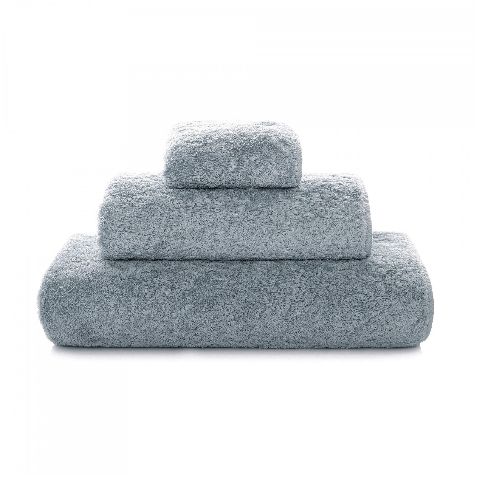 Soft white Graccioza Egoist hand towel with textured weave, displayed folded on a clean bathroom surface.