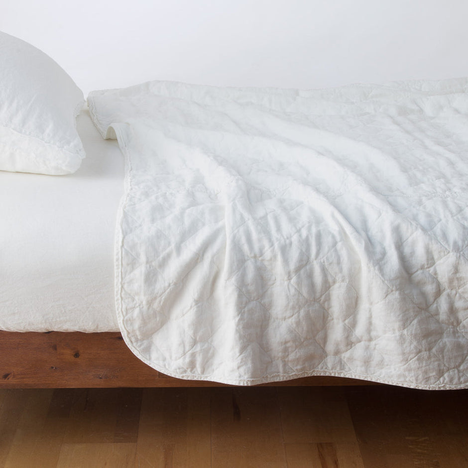 White Bella Notte Austin Coverlet on a king-size bed, showcasing elegant, soft bedding with a textured fabric finish.