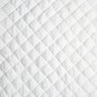 Queen-sized Bell Notte quilted silk velvet coverlet in winter white with a luxurious, textured quilted design.