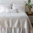 Queen-sized Bella Notte quilted silk velvet coverlet in winter white with a plush, quilted texture for luxurious bedding.