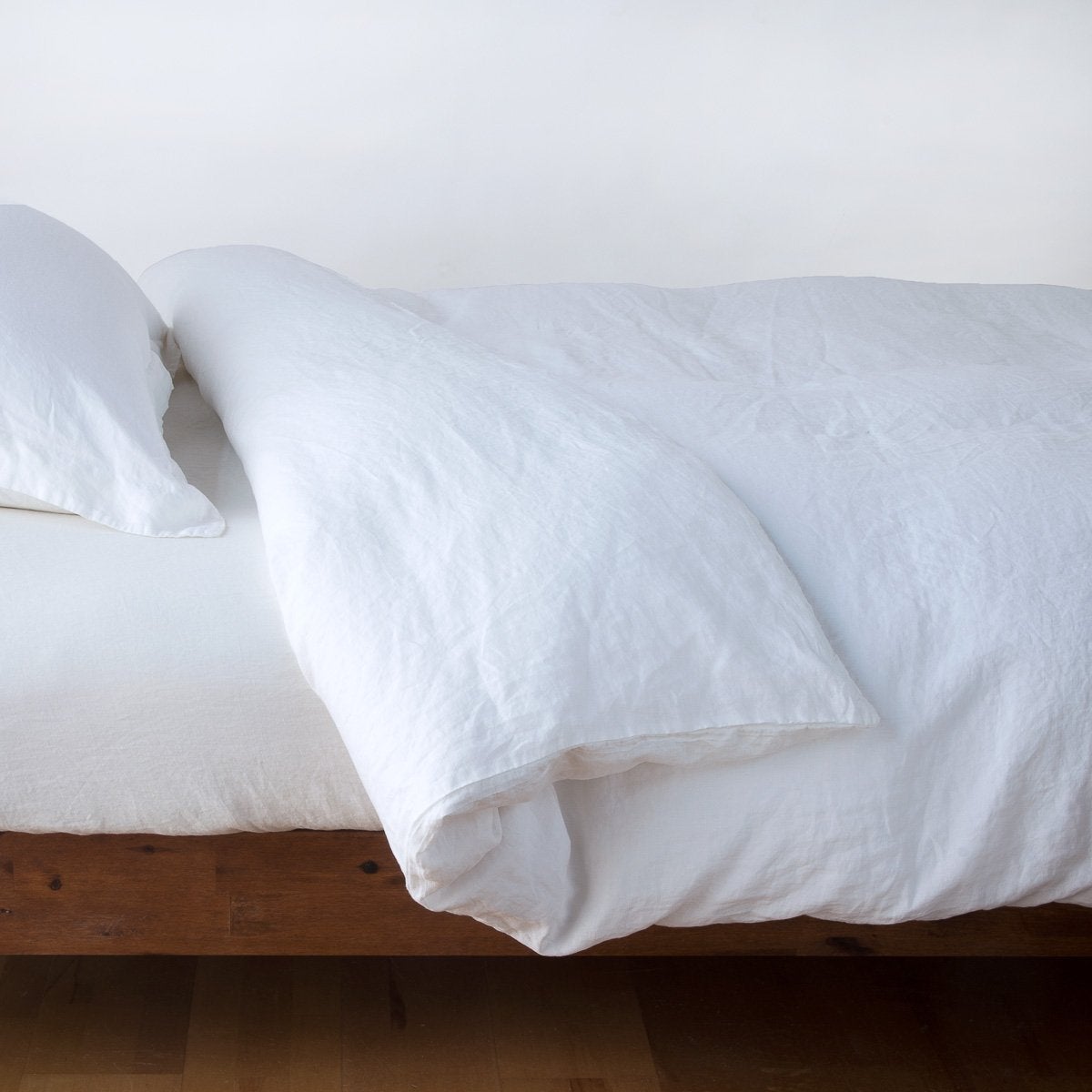 White linen duvet cover for queen size bed by Bella Notte, showcasing soft, textured fabric with a relaxed, elegant look.