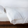 White linen duvet cover in winter white color by Bella Notte, designed for a king-size bed, with a soft, textured fabric.