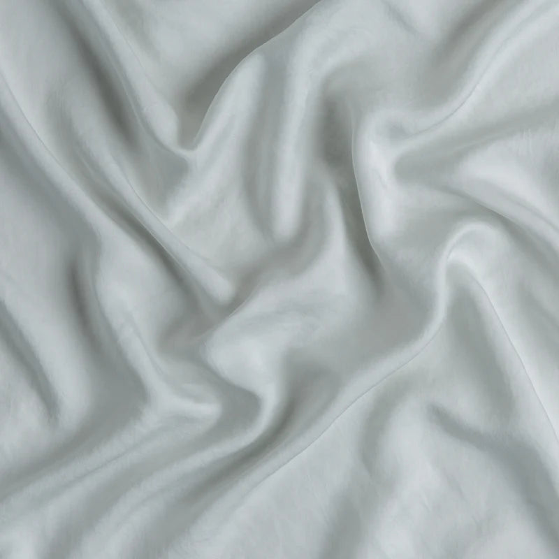 In Stock Bella Notte Madera Luxe fitted sheet in Cloud color, featuring soft, luxurious fabric for queen size beds.