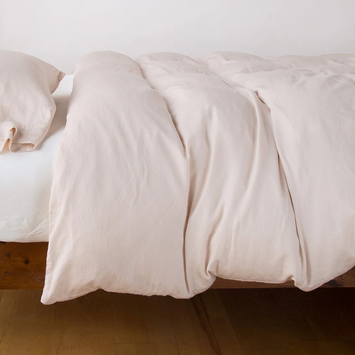 In Stock Bella Notte Madera Luxe Pearl Queen duvet cover with soft, luxurious fabric and elegant design on a neatly made bed.