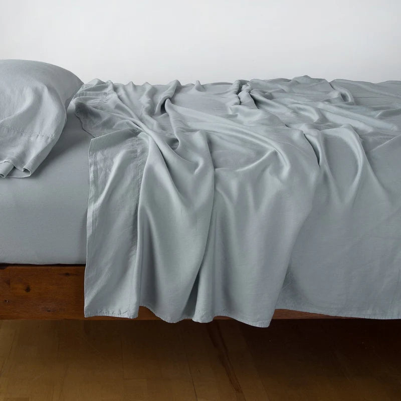 In Stock Bella Notte Madera Luxe flat sheet in Tahoe Blue for king size bed, showcasing soft, luxurious fabric and elegant design.