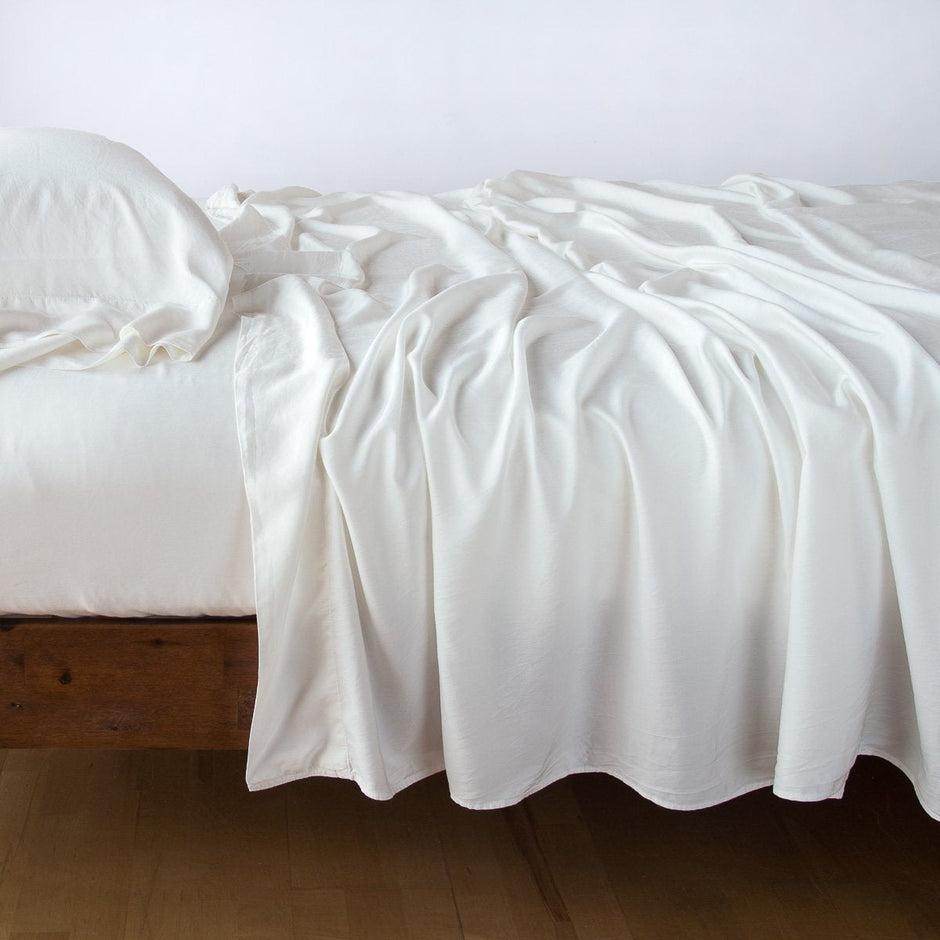 In Stock Bella Notte Madera Luxe Flat Sheet in Winter White, queen size, showcasing soft, luxurious bedding fabric.
