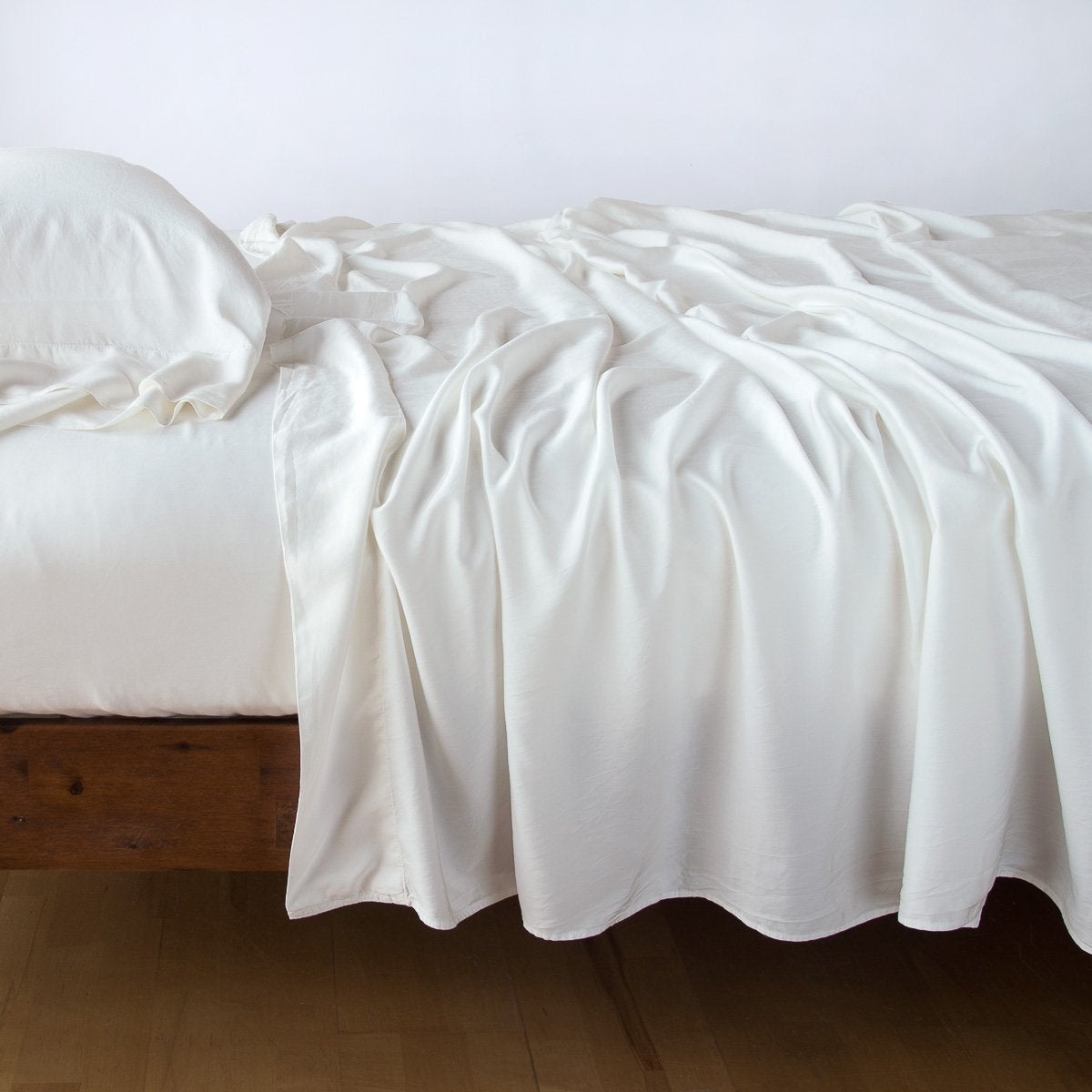 In Stock Bella Notte Madera Luxe Flat Sheet in Winter White, queen size, showcasing soft, luxurious bedding fabric.