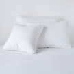 White Austin Sham Deluxe by Bella Notte, plush fabric with elegant stitching, designed for a luxurious bedroom look.