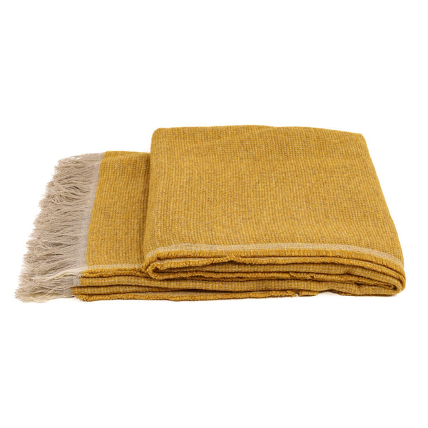 White Uniq'uity Allen throw blanket, soft and cozy textile perfect for adding warmth and style to any living space.