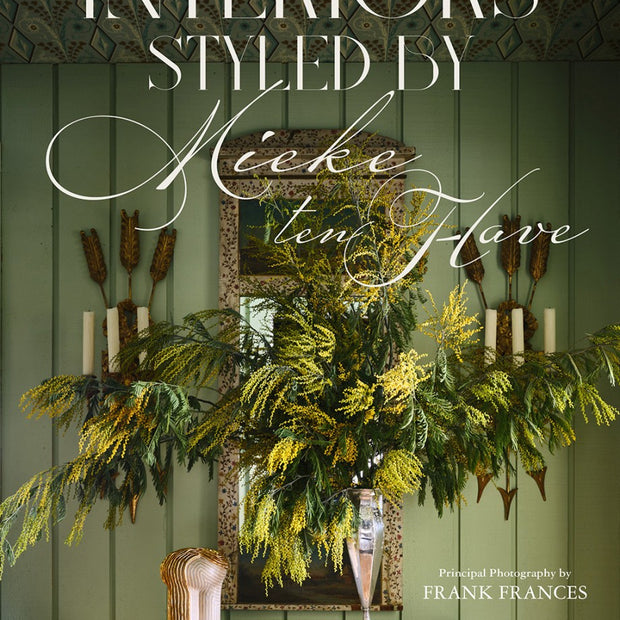 Book cover with decorative elements and text 'Interiors Styled by Neeke ten Hove' on a green background.