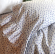 Lilac Rosebud Tatter Ruffle Sham from Linen Salvage, standard size, featuring delicate ruffled edges and floral embroidery.