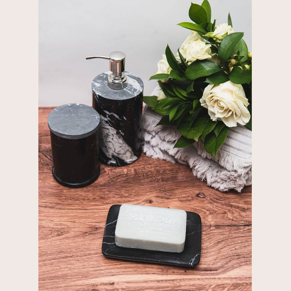 Black marble soap dish from Lothantique Inc., rounded bath accessory with smooth, polished surface for bathroom decor.