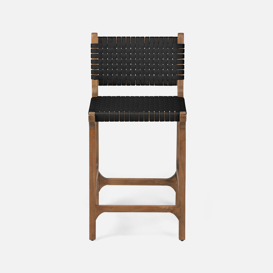 Made Goods Rawley counter stool with aged natural teak frame and black faux rattan seat, showcasing a stylish dining chair design.