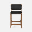 Made Goods Rawley counter stool with aged natural teak frame and black faux rattan seat, showcasing a stylish dining chair design.