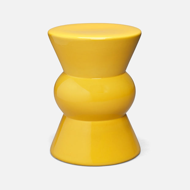 Made Goods Teagan Stool in vibrant lemon yellow, serving as a stylish side table with a sleek, modern design.