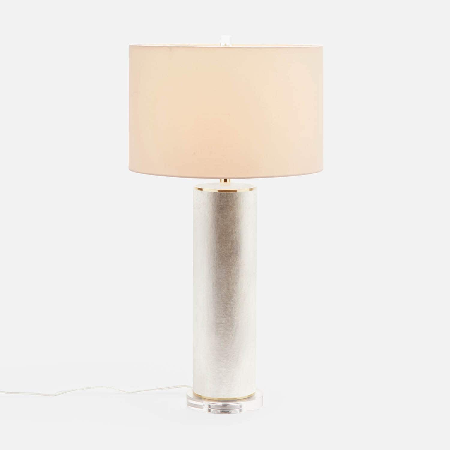 Made Goods Tavis Table Lamp with warm silver finish, featuring a sleek modern design and a cylindrical lampshade.