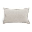 A rectangular lumbar throw pillow in a textured light beige fabric with piped edges, shown on a plain white background.