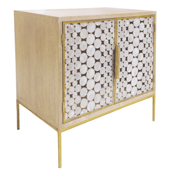 A bedside table with a driftwood finish and gold base featuring two polished capiz shell doors.