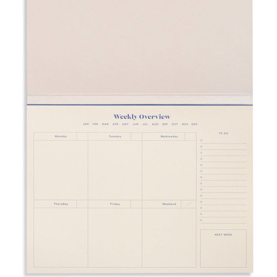 Blue Joy Undated Weekly Desk Planner by Papier with open pages showing daily and weekly scheduling sections.